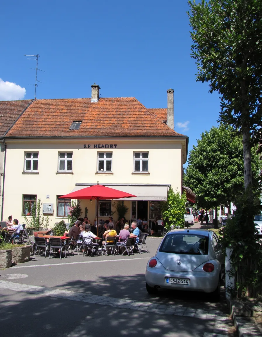 Sunny summer day at a German cafe with outdoor seating, a blue sky, and a silver VW car parked nearby with a European license plate