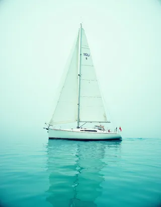 A minimalist white sailboat with a single sail glides calmly on turquoise water, captured in soft diffused lighting with pastel colors and a serene, cinematic atmosphere.